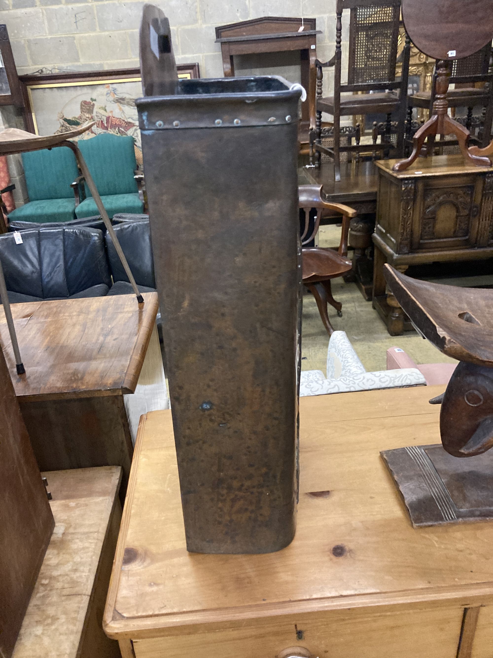 In the manner of Baillie Scott, an Arts and Crafts embossed pewter and copper stick stand, width 32cm, depth 15cm, height 70cm